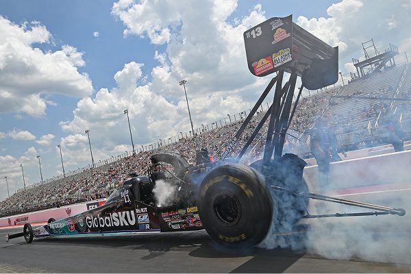 The GlobalSKU dragster doing a burnout at the starting line